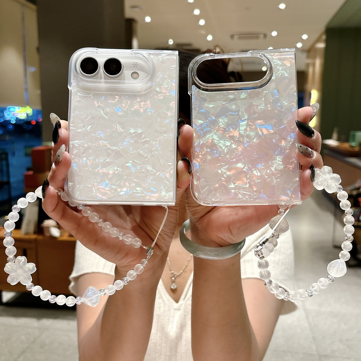 iPhone Duo pearl shell case shown with matching beaded wrist strap