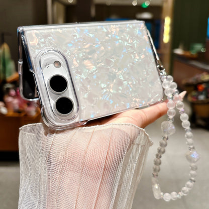 Side view of iPhone Duo pearl shell case with iridescent finish and wrist strap