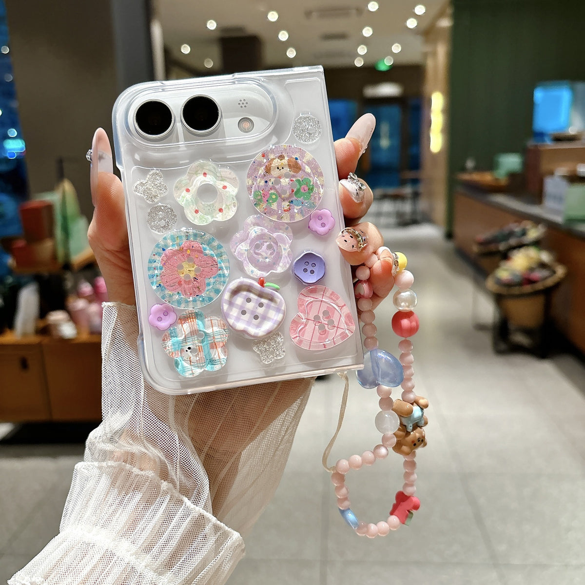iPhone Duo 3D button charm case with pastel decorations and beaded wrist strap