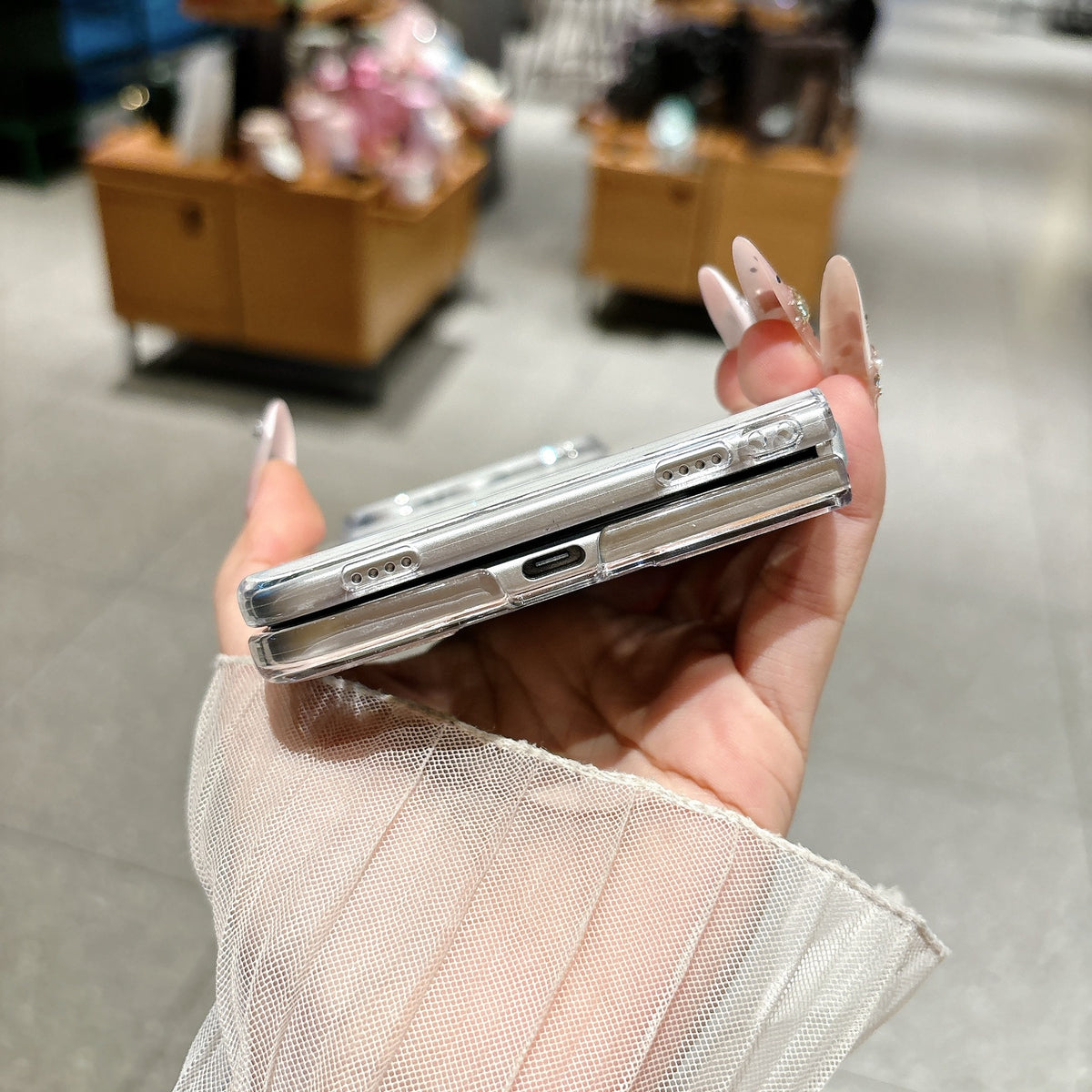 Bottom view of iPhone Duo protective case showing charging port and speaker cutouts
