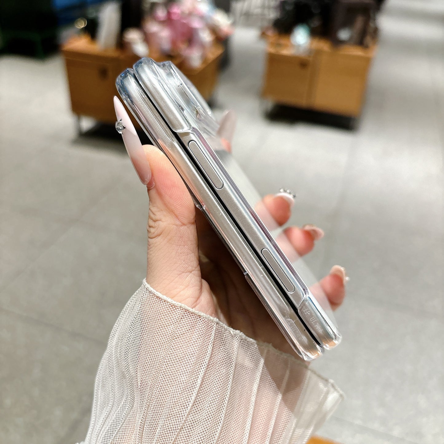 Side profile of iPhone Duo clear protective case showing button cutouts and slim fit
